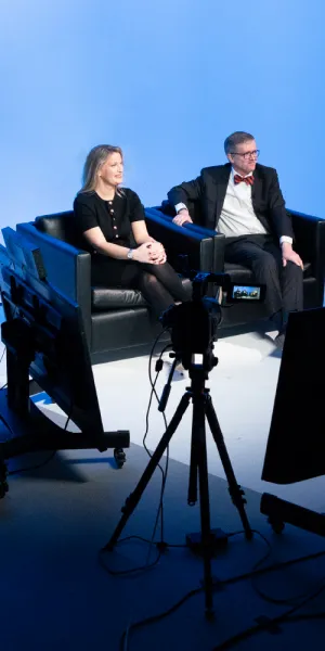 People sitting on a TV set